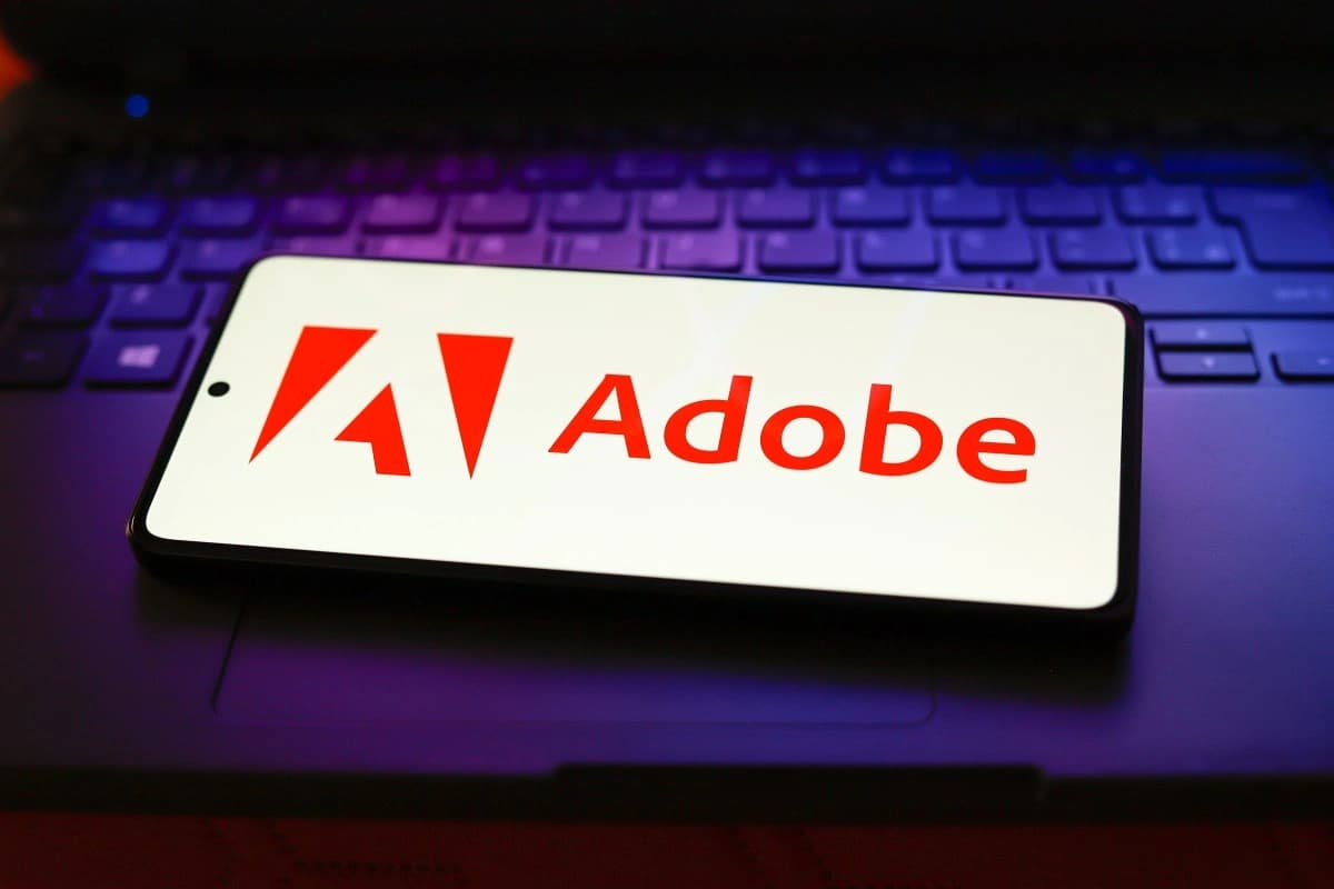 Logotipo da Adobe em uma tela de smartphone, ilustrando a aquisição da Rilo para automatizar workflows de marketing